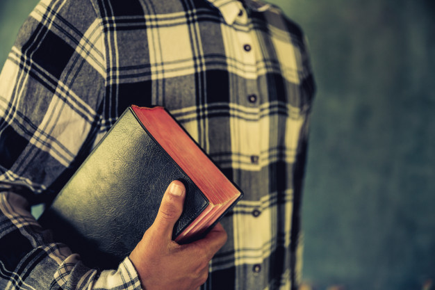 young-man-holding-bible-his-hands_1150-7166